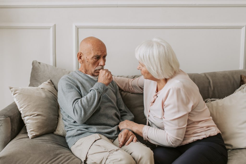 Older couple in their home in a caring moment
