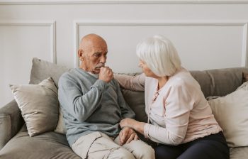 Older couple in their home in a caring moment